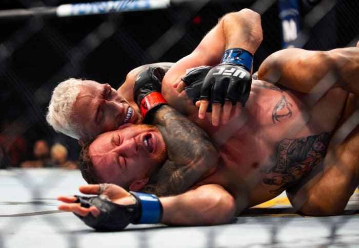 Charles Oliveira (left) chokes out Justin Gaethje during UFC 274 at the Footprint Center.