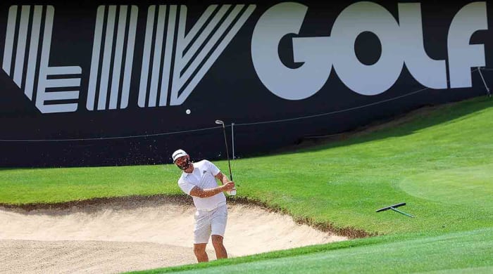 Dustin Johnson is shown hitting out of a bunker at the 2022 LIV Golf Invitational Jeddah.