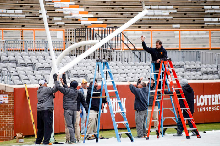 Workers reinstall the goalposts at Neyland Stadium.