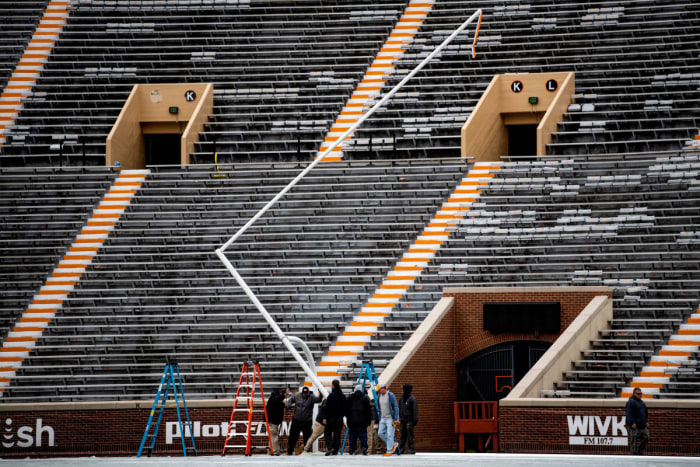 Workers erect new goal posts at Neyland Stadium.