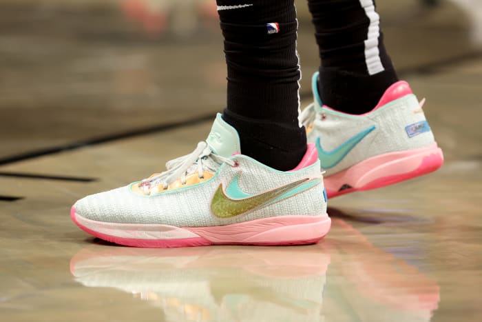 Light green and pink Nike LeBron 20 shoes.