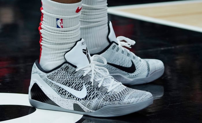White and black Nike Kobe 9 shoes.
