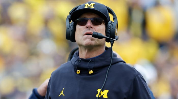 Michigan coach Jim Harbaugh watches from the sidelines during a game.