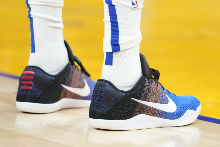 View of black, blue, and white Nike Kobe shoes.