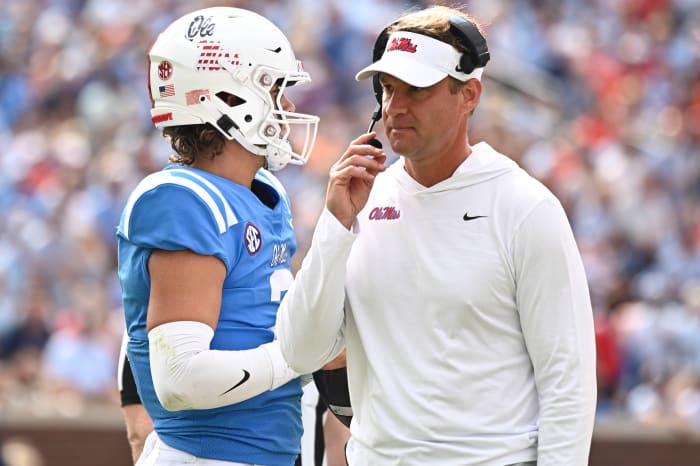 Oct 15, 2022; Oxford, Mississippi, USA; Mississippi Rebels head coach Lane Kiffin speaks with quarterback Jaxson Dart (2) during a timeout during the first quarter of the game against the Auburn Tigers at Vaught-Hemingway Stadium. Mandatory Credit: Matt Bush-USA TODAY Sports