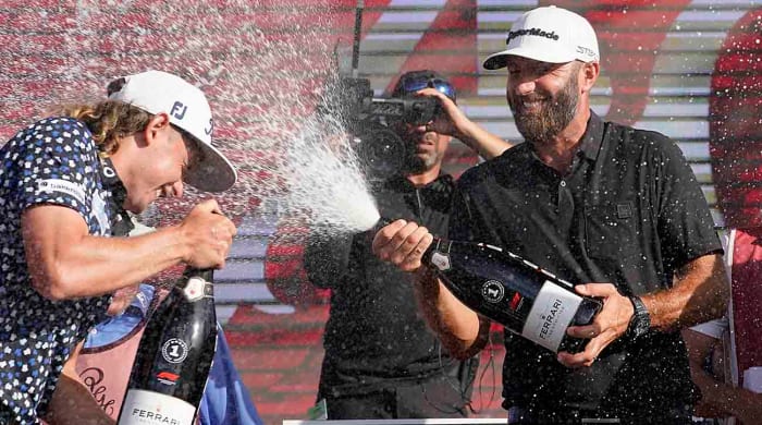 Dustin Johnson sprays champagne at the 2022 LIV Golf Team Championship in Doral, Florida.