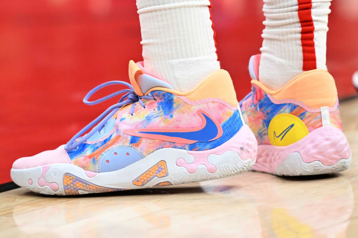 View of pink and blue Nike PG shoes.