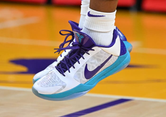 View of the white, purple and teal Nike Kobe shoes.