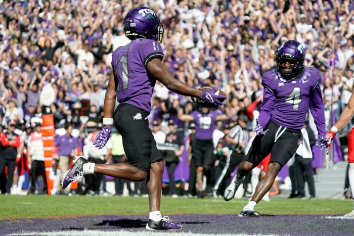 TCU wide receiver Derius Davis runs into the end zone while a teammate next to him reacts