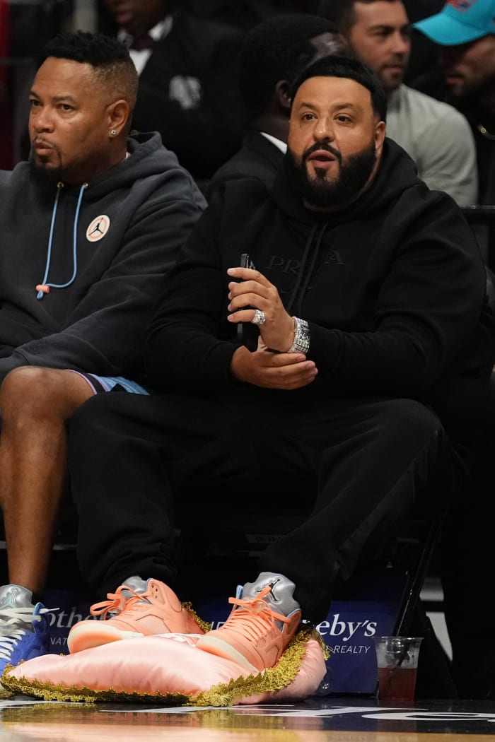 DJ Khaled sits courtside during a game.