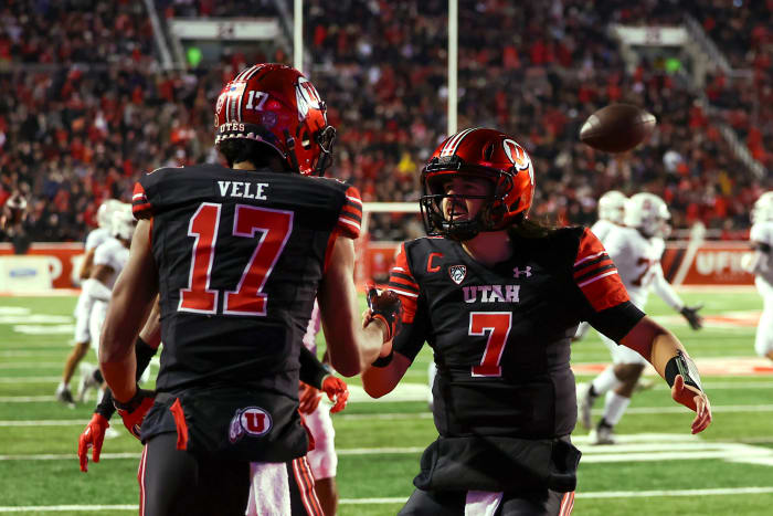 Utah Utes wide receiver Devaughn Vele (17) and quarterback Cameron Rising (7) celebrate after a touchdown against the Stanford Cardinal in the second quarter at Rice-Eccles Stadium.