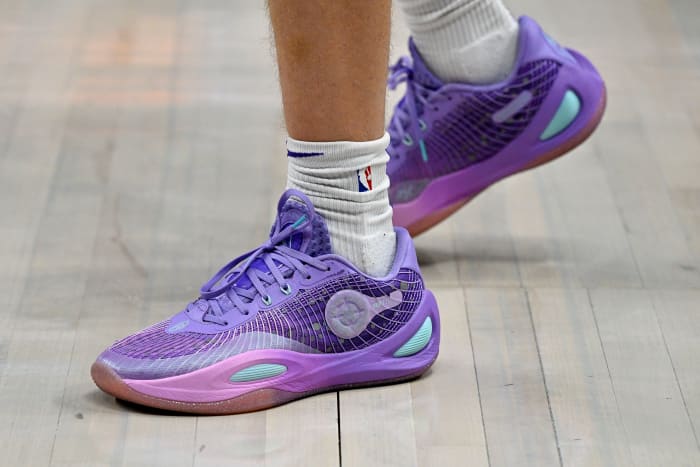 Los Angeles Lakers guard Austin Reaves' purple and teal sneakers.