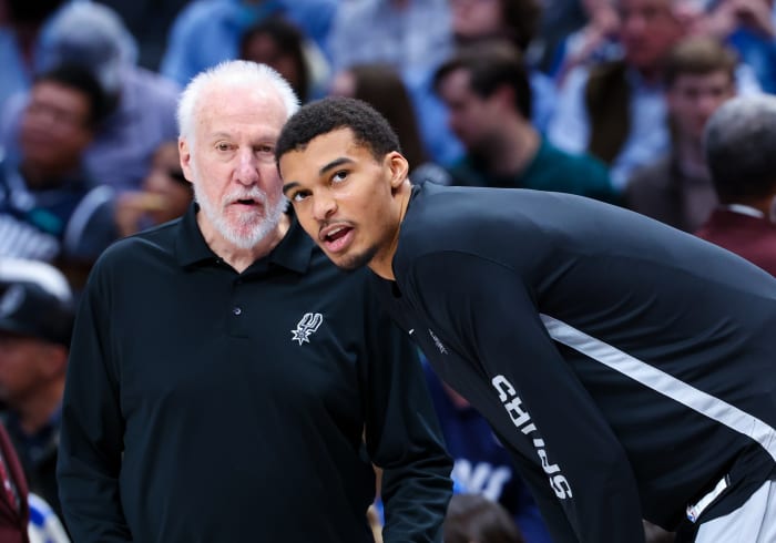 Dec 23, 2023; Dallas, Texas, USA; San Antonio Spurs head coach Gregg Popovich speaks with San Antonio Spurs center Victor Wembanyama (1) before the game against the Dallas Mavericks at American Airlines Center.