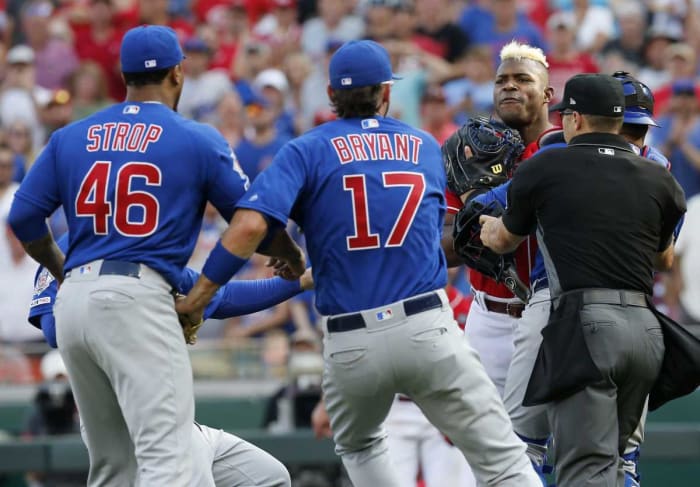 Cincinnati Reds right fielder Yasiel Puig (66) charges the mound after being hit by Chicago Cubs relief pitcher Pedro Strop (46) in the eighth inning at Great American Ball Park on Saturday, June 29, 2019. Chicago Cubs At Cincinnati Reds 