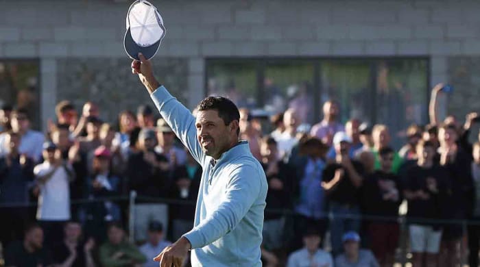 Charl Schwartzel waves to the crowd after winning the inaugural LIV Golf event in 2022 at the Centurion Club outside London.