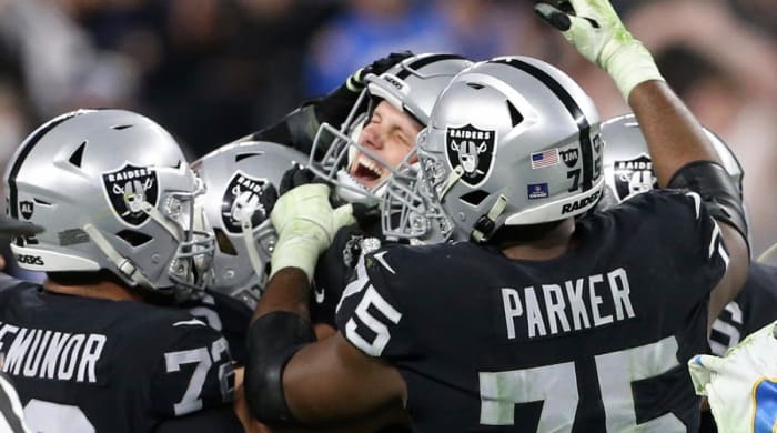 Las Vegas Raiders kicker Daniel Carlson, center, celebrates after kicking the game-winning field goal against the Los Angeles Chargers during overtime of an NFL football game, Sunday, January 9. of 2022, in Las Vegas.