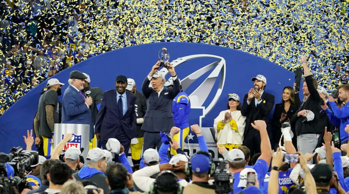 Los Angeles Rams owner Stan Kroenke, middle, holds up the George Halas trophy after the Rams defeated the San Francisco 49ers in the NFC Championship NFL football game Sunday, Jan. 30, 2022, in Inglewood, Calif.  The Rams won 20-17 going into the Super Bowl.