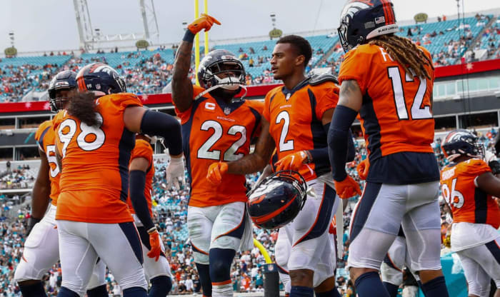 Denver Broncos strong safety Kareem Jackson (22) celebrates after a reception by cornerback Pat Surtain II (2) in the fourth quarter against the Jacksonville Jaguars at TIAA Bank Field.