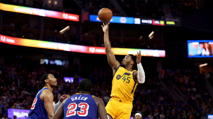 Utah Jazz guard Donovan Mitchell (45) shoots against Golden State Warriors forwards Otto Porter Jr., left, and Draymond Green (23) during the second half of an NBA basketball game in San Francisco, Saturday, April 2, 2022.