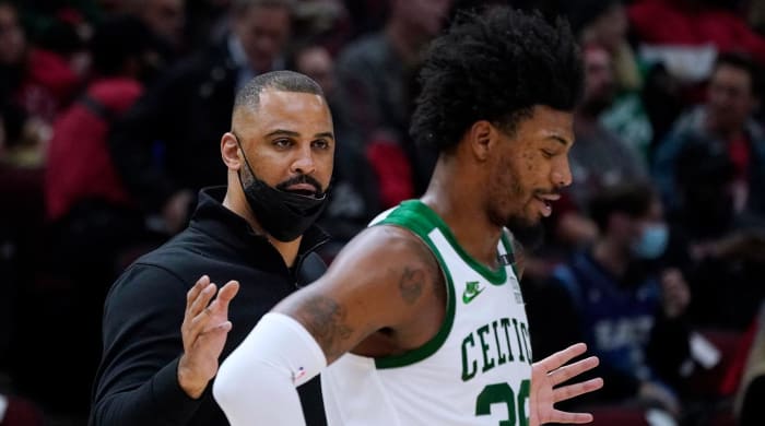 Boston Celtics coach Ime Udoka, left, talks to guard Marcus Smart during the first half of the team’s NBA basketball game against the Chicago Bulls in Chicago, Wednesday, April 6, 2022.
