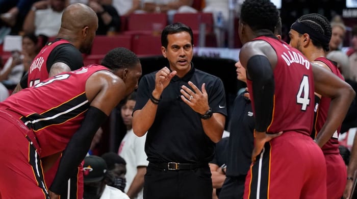 Miami Heat head coach Erik Spoelstra, center, speaks to players as officials watch a game during the second half of Game 5 of a first round NBA basketball playoff series against the Atlanta Hawks on Tuesday, April 26, 2022, in Check Miami.