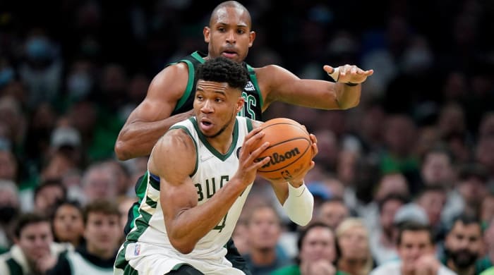 Milwaukee Bucks forward Giannis Antetokounmpo, front, of Greece, drives past Boston Celtics center Al Horford, top, in the second half of Game 1 in the second round of the NBA Eastern Conference playoff series, Sunday, May 1, 2022, in Boston.
