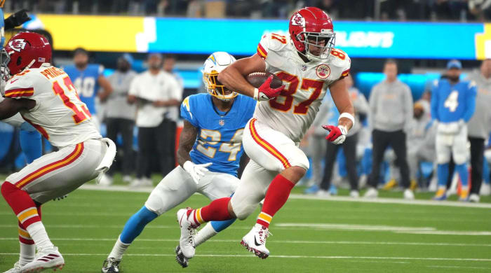 December 16, 2021;  Inglewood, California, USA;  Kansas City Chiefs tight end Travis Kelce (87) is chased by Los Angeles Chargers safety Nasir Adderley (24) during an overtime touchdown reception against the Los Angeles Chargers at SoFi Stadium.