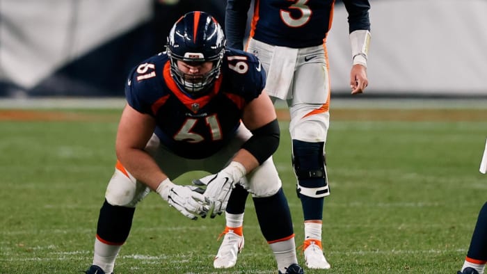 Denver Broncos quarterback Drew Lock (3) behind offensive guard Graham Glasgow (61) and center Lloyd Cushenberry III (79) in the fourth quarter against the Tennessee Titans at Empower Field at Mile High.