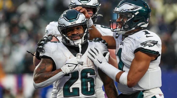 Dec 11, 2022;  East Rutherford, New Jersey, USA;  Philadelphia Eagles running back Miles Sanders (26) celebrates with quarterback Jalen Hurts (1) after scoring a touchdown against the New York Giants during the fourth quarter at MetLife Stadium.