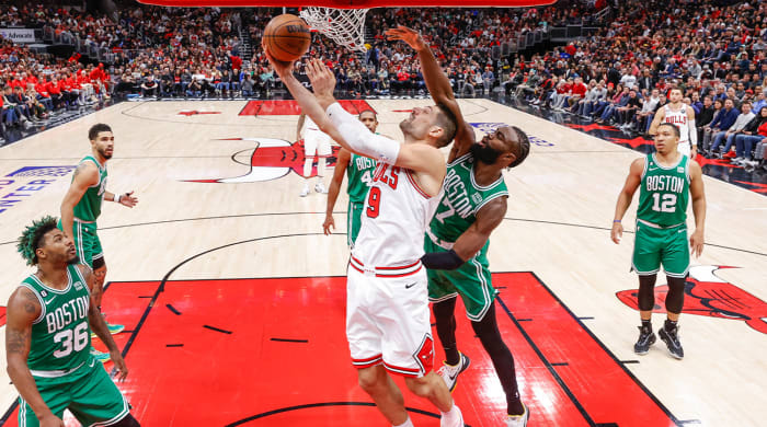 Nov 21, 2022;  Chicago, Illinois, USA;  Chicago Bulls center Nikola Vucevic (9) goes to the basket against Boston Celtics guard Jaylen Brown (7) during the second half at United Center.