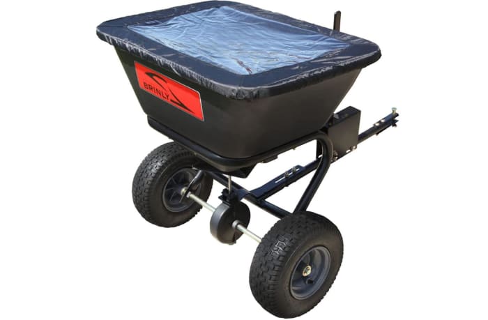 Tow behind spreader with waterproof cover