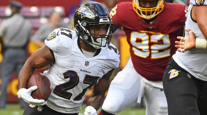 August 28, 2021;  Landover, Maryland, USA;  The Baltimore Ravens running back J.K. Dobbins (27) holds the ball against the Washington FC during the first quarter at FedExField.