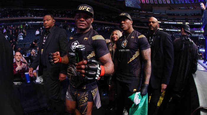 November 6, 2021;  New York, New York, USA;  Kamaru Usman (red glove) leaves the Octagon with his championship belt after defeating Colby Covington (blue glove) during UFC 268 at Madison Square Garden.