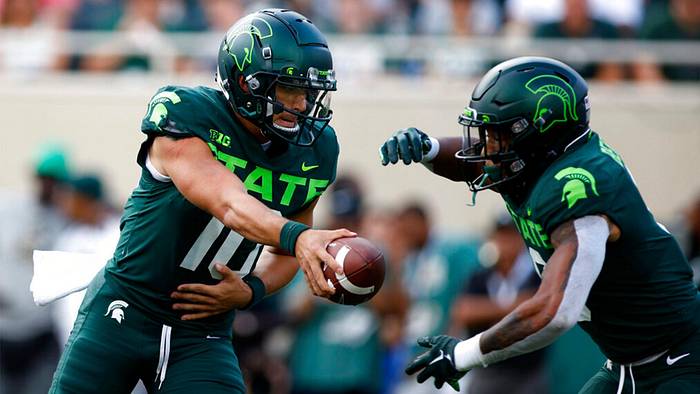 Michigan State quarterback Payton Thorne, left, hands off to running back Jalen Berger during the second quarter of an NCAA college football game against Akron, Saturday, Sept.  10, 2022, in East Lansing, Mich.