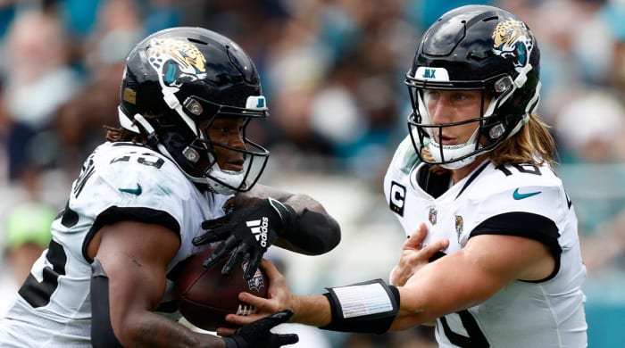 Sep 18, 2022; Jacksonville, Florida, USA; Jacksonville Jaguars quarterback Trevor Lawrence (16) hands the ball off to running back James Robinson (25) against the Indianapolis Colts during the third quarter at TIAA Bank Field.