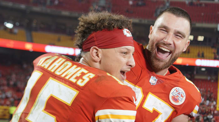 October 10, 2022;  Kansas City, Missouri, USA;  Kansas City Chiefs quarterback Patrick Mahomes (15) interrupts Travis Kelsey's court end (87) while speaking to a post-game report against the Las Vegas Raiders at GEHA Field at Arrowhead Stadium.