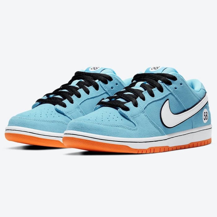View of blue, white, and orange Nike Dunk shoes.