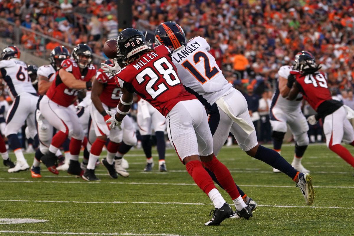 Atlanta Falcons defensive back Jordan Miller (28) defends as Denver Broncos wide receiver Brendan Langley (12) makes a catch in the first half at Tom Benson Hall of Fame Stadium.