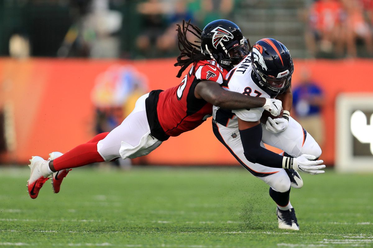 Atlanta Falcons defensive back Kemal Ishmael (36) tackles Denver Broncos tight end Noah Fant (87) in the first half at Tom Benson Hall of Fame Stadium