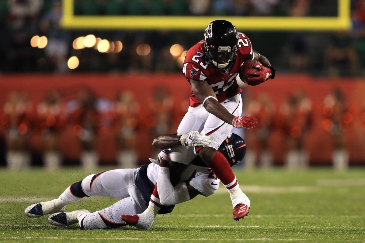 Denver Broncos cornerback Horace Richardson (27) tackles Atlanta Falcons running back Brian Hill (23) in the first half at Tom Benson Hall of Fame Stadium.