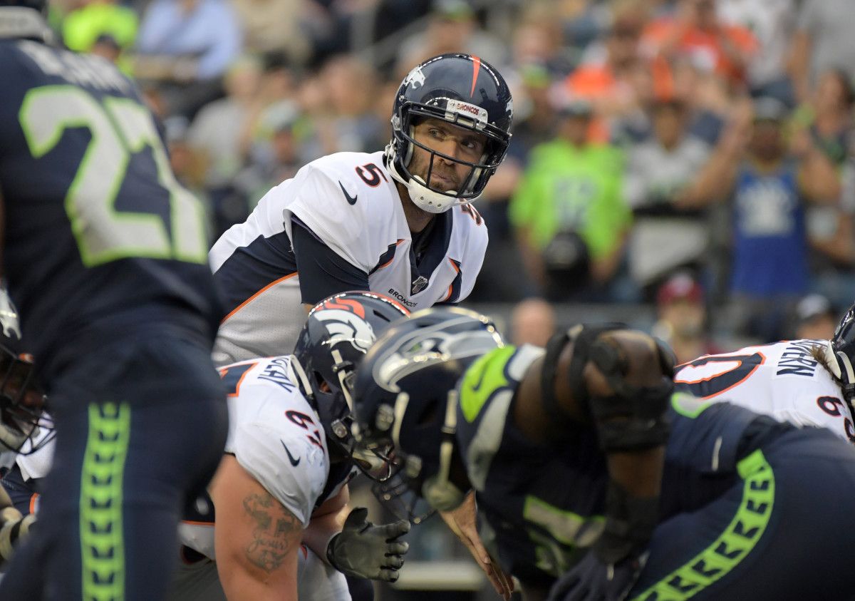 Denver Broncos quarterback Joe Flacco (5) looks over the line of scrimmage against the Seattle Seahawks in the first quarter at CenturyLink Field.