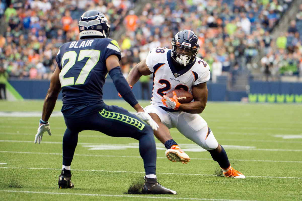 Denver Broncos running back Royce Freeman (28) picks up a first down against Seattle Seahawks defensive back Marquise Blair (27) during the first half at CenturyLink Field.