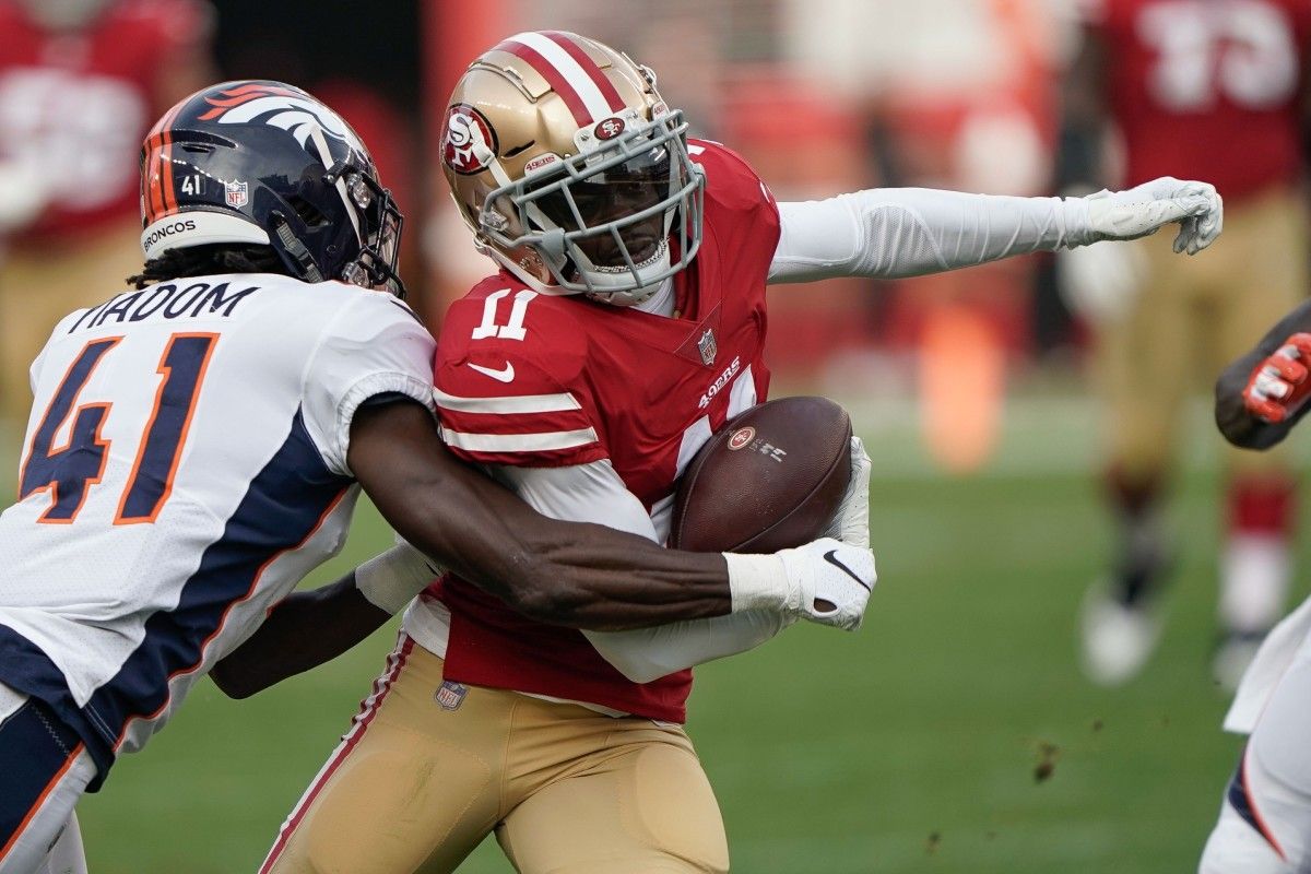 Denver Broncos cornerback Isaac Yiadom (41) tackles San Francisco 49ers wide receiver Marquise Goodwin (11) during the second quarter at Levi's Stadium.
