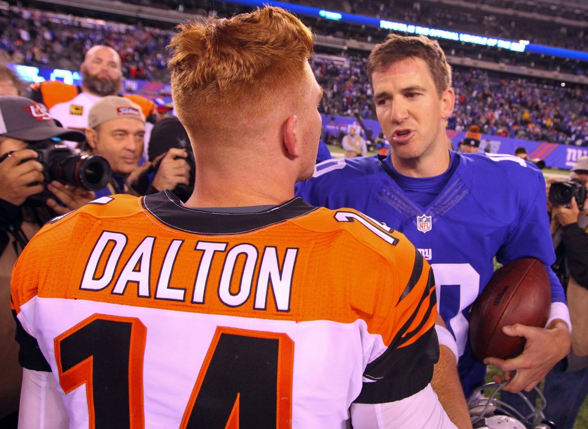 Nov 14, 2016; East Rutherford, NJ, USA; Cincinnati Bengals quarterback Andy Dalton (14) and New York Giants quarterback Eli Manning (10) meet on the field after their game at MetLife Stadium. The Giants defeated the Bengals 21-20.