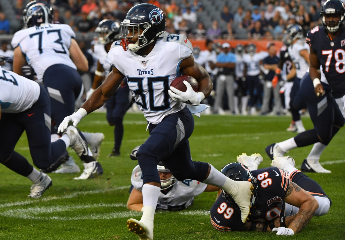 Tennessee Titans running back Jeremy McNichols (30) rushes the ball past Chicago Bears outside linebacker Aaron Lynch (99) during the first half at Soldier Field.