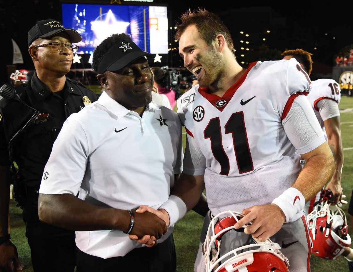 Coach Mason congratulates Jake Fromm after the victory