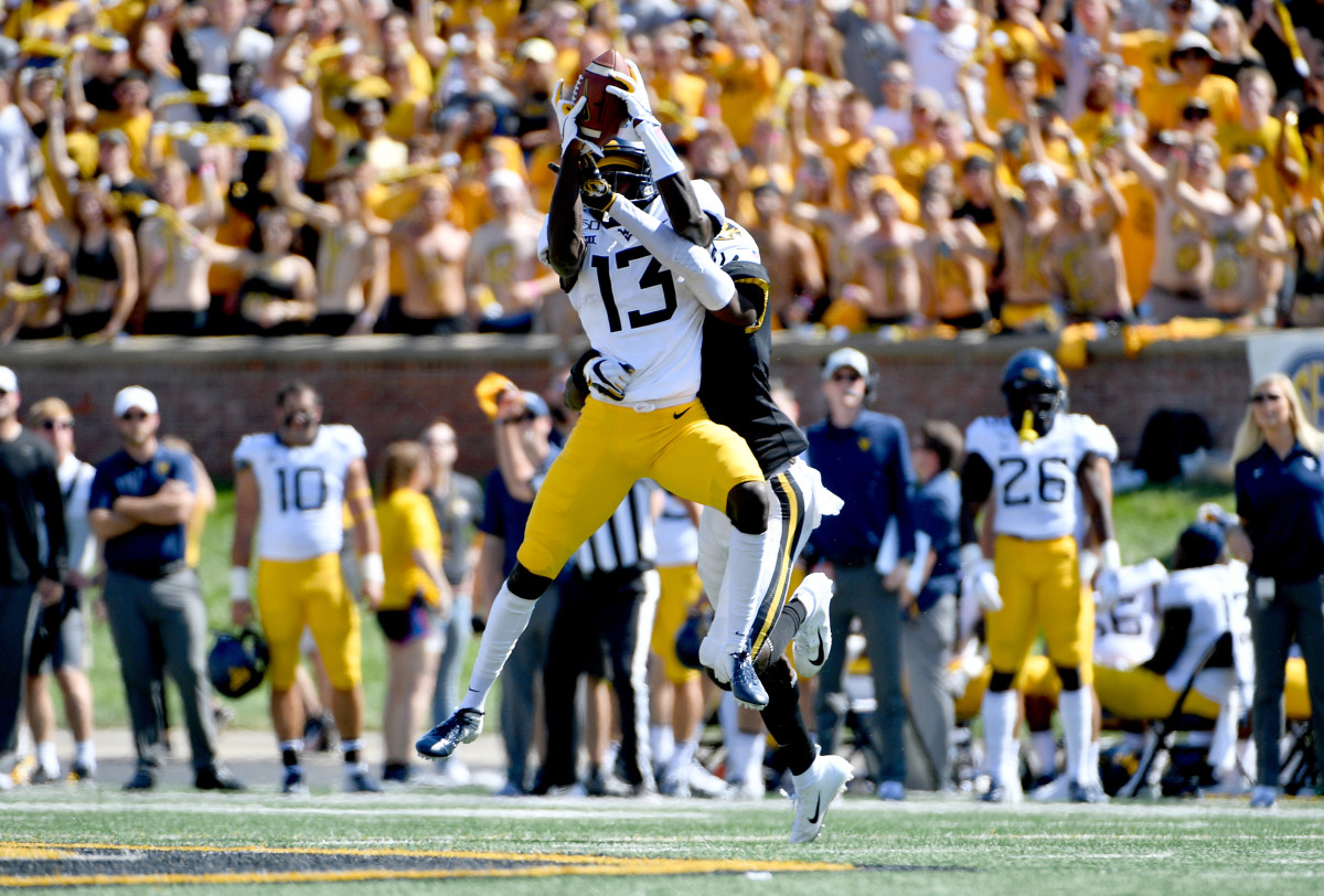 West Virginia wide receiver Sam James (13) makes a catch as Missouri defensive back DeMarkus Acy defends during the Mountaineers loss on Saturday