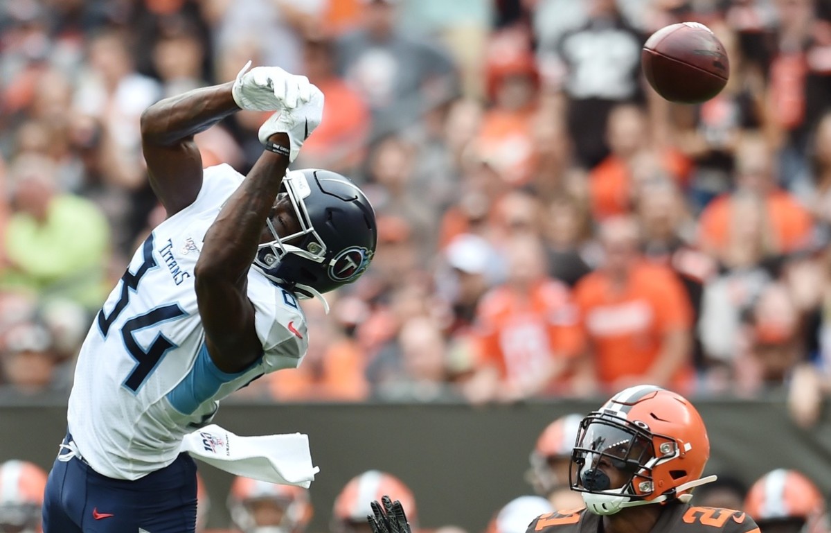 Tennessee Titans wide receiver Corey Davis (84) leaps for the ball but can not make the catch as Cleveland Browns cornerback Denzel Ward (21) defends during the first half at FirstEnergy Stadium.