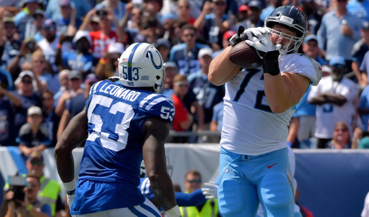 Tennessee Titans offensive tackle David Quessenberry (72) catches a pass for a touchdown against Indianapolis Colts outside linebacker Darius Leonard (53) during the first half at Nissan Stadium.