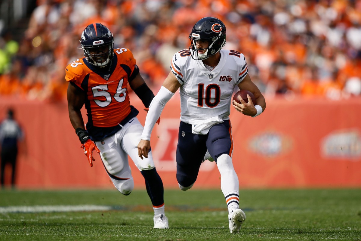 Chicago Bears quarterback Mitchell Trubisky (10) runs the ball ahead of Denver Broncos linebacker Corey Nelson (56) in the first quarter at Empower Field at Mile High.